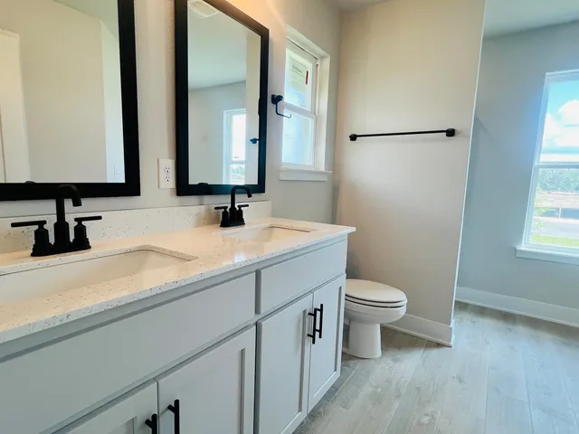 a bathroom with a double vanity sink and mirror