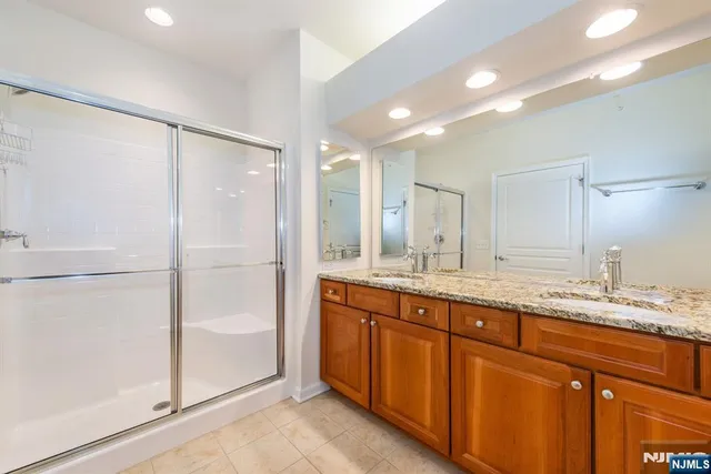 a bathroom with a granite countertop sink mirror and double