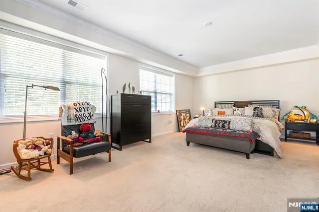 a bedroom with furniture and a flat screen tv