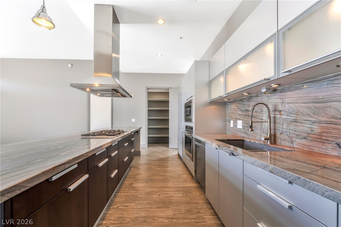 2775 West Pebble Road, Unit 505 Las Vegas, NV 89123 - Photo 6 of 26 A streamlined kitchen showcasing elegant countertops, a built-in range, and a spacious pantry.