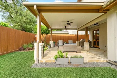 a view of a backyard with sitting area