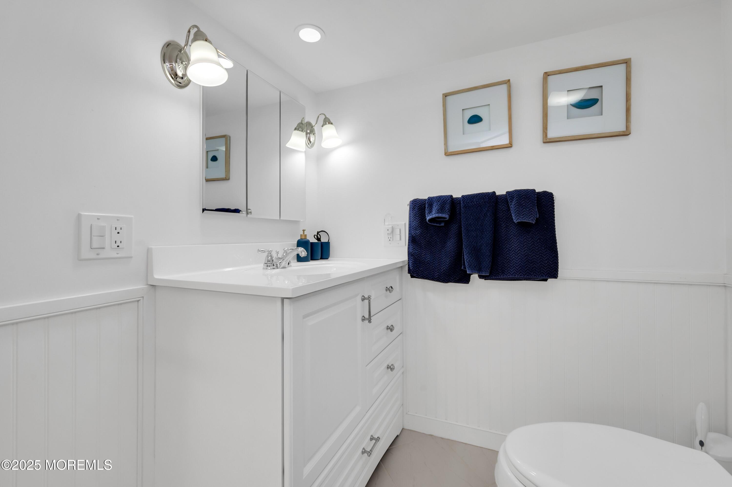 15 Hillside Street Red Bank, NJ 07701 - Photo 25 of 39 a bathroom with a sink vanity mirror and toilet