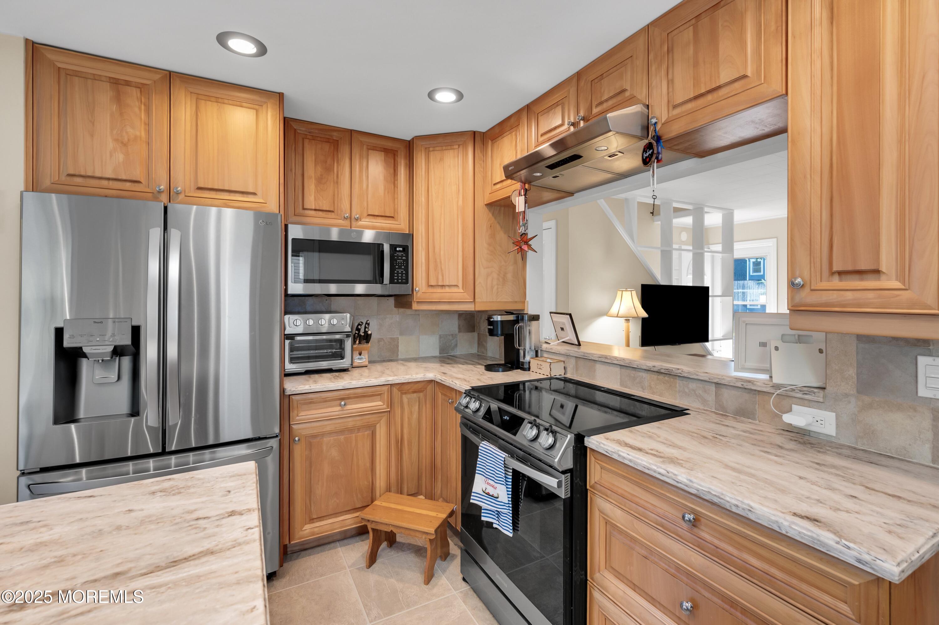 15 Hillside Street Red Bank, NJ 07701 - Photo 5 of 39 a kitchen with granite countertop a refrigerator stove and sink