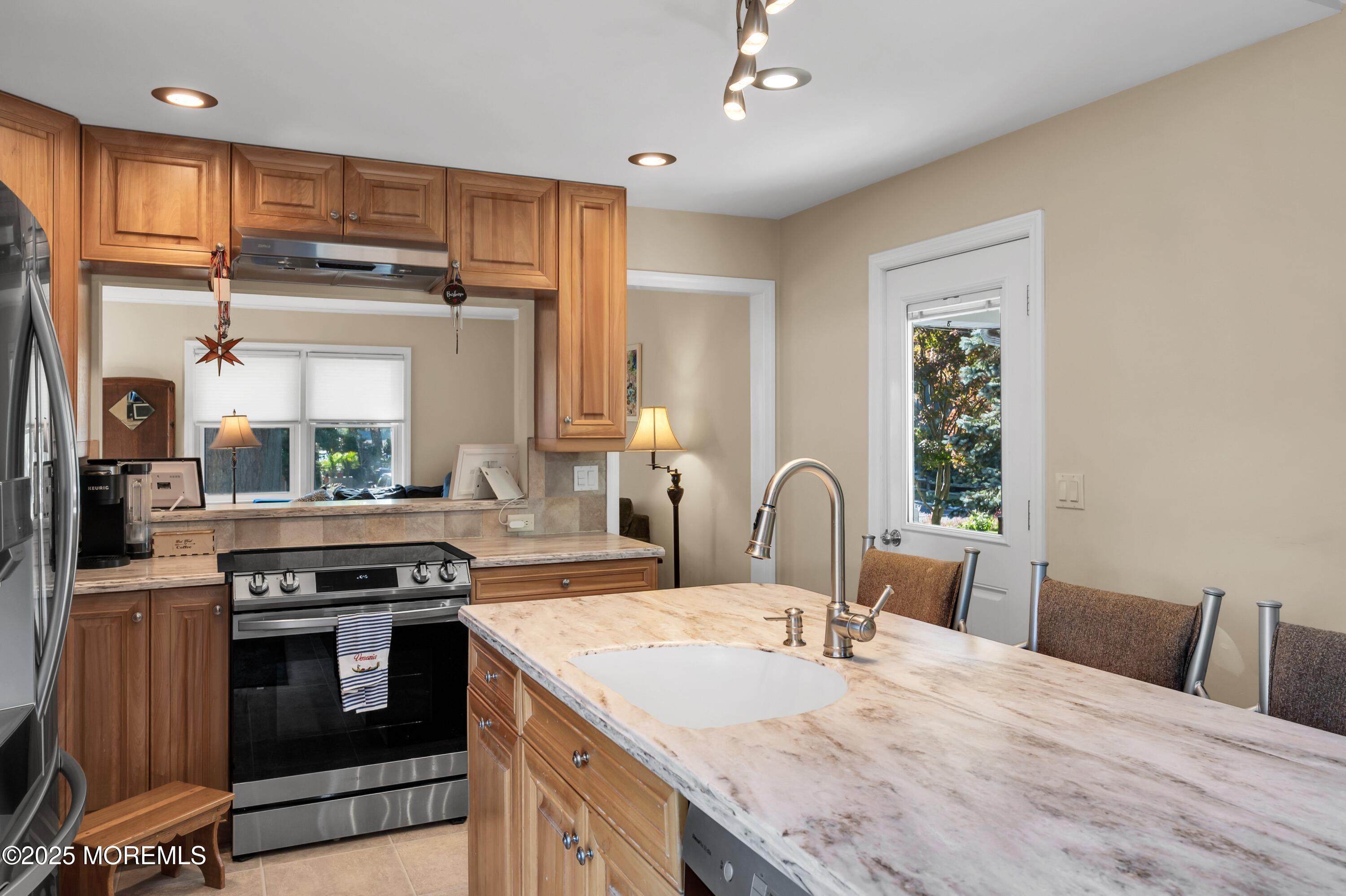 15 Hillside Street Red Bank, NJ 07701 - Photo 6 of 39 a kitchen with stainless steel appliances granite countertop a stove a sink and a refrigerator