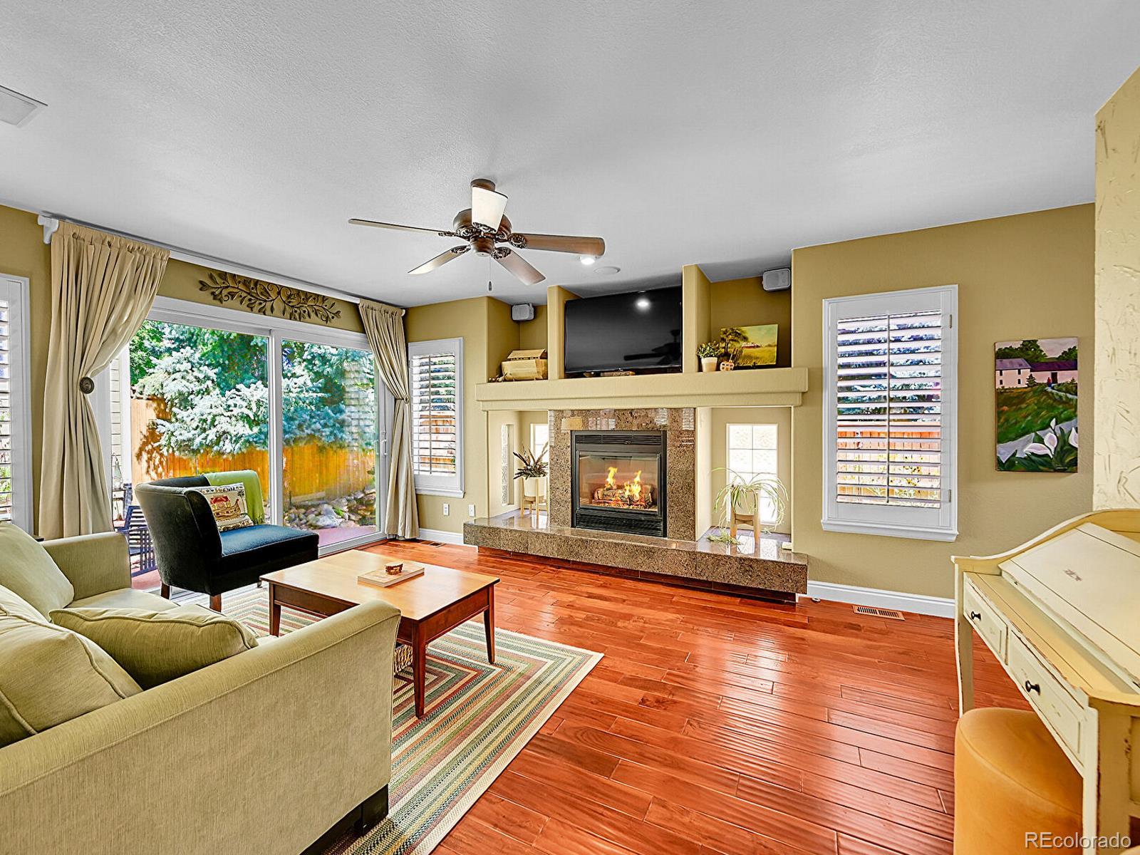 1221 Braewood Avenue Highlands Ranch, CO 80129 - Photo 11 of 45 a living room with furniture and a fireplace