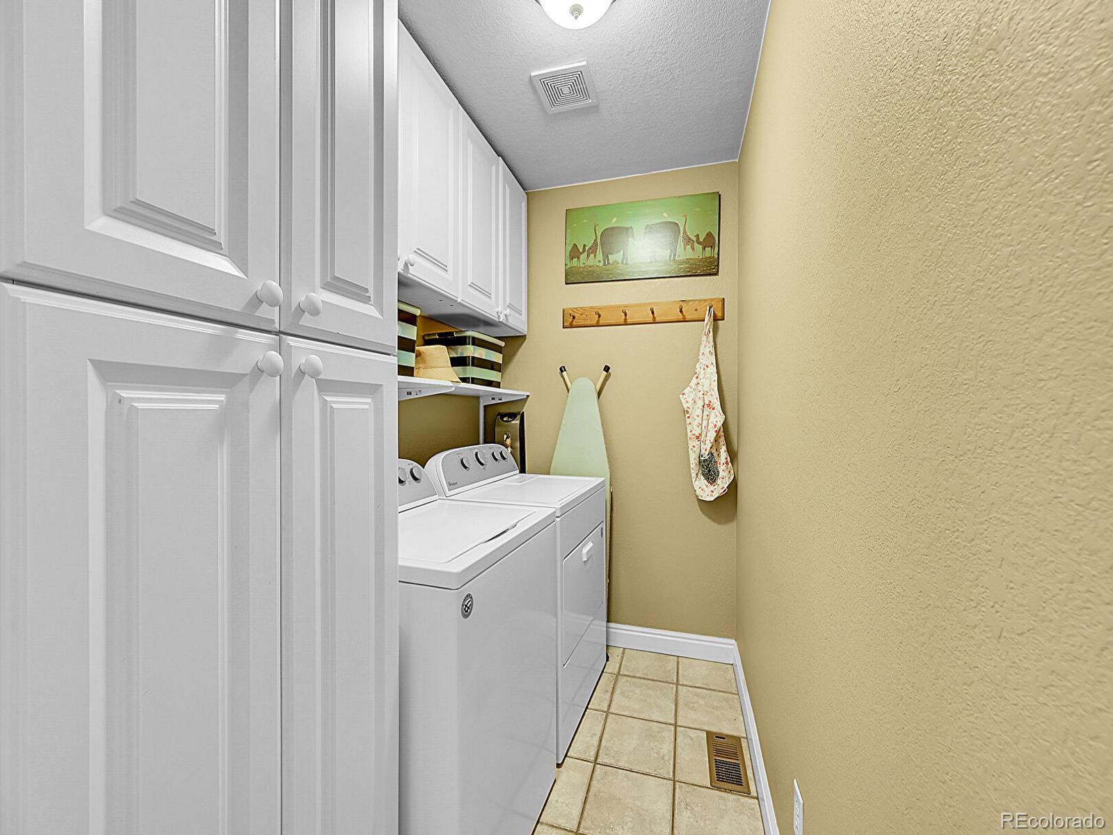 1221 Braewood Avenue Highlands Ranch, CO 80129 - Photo 15 of 45 a utility room with dryer and washer