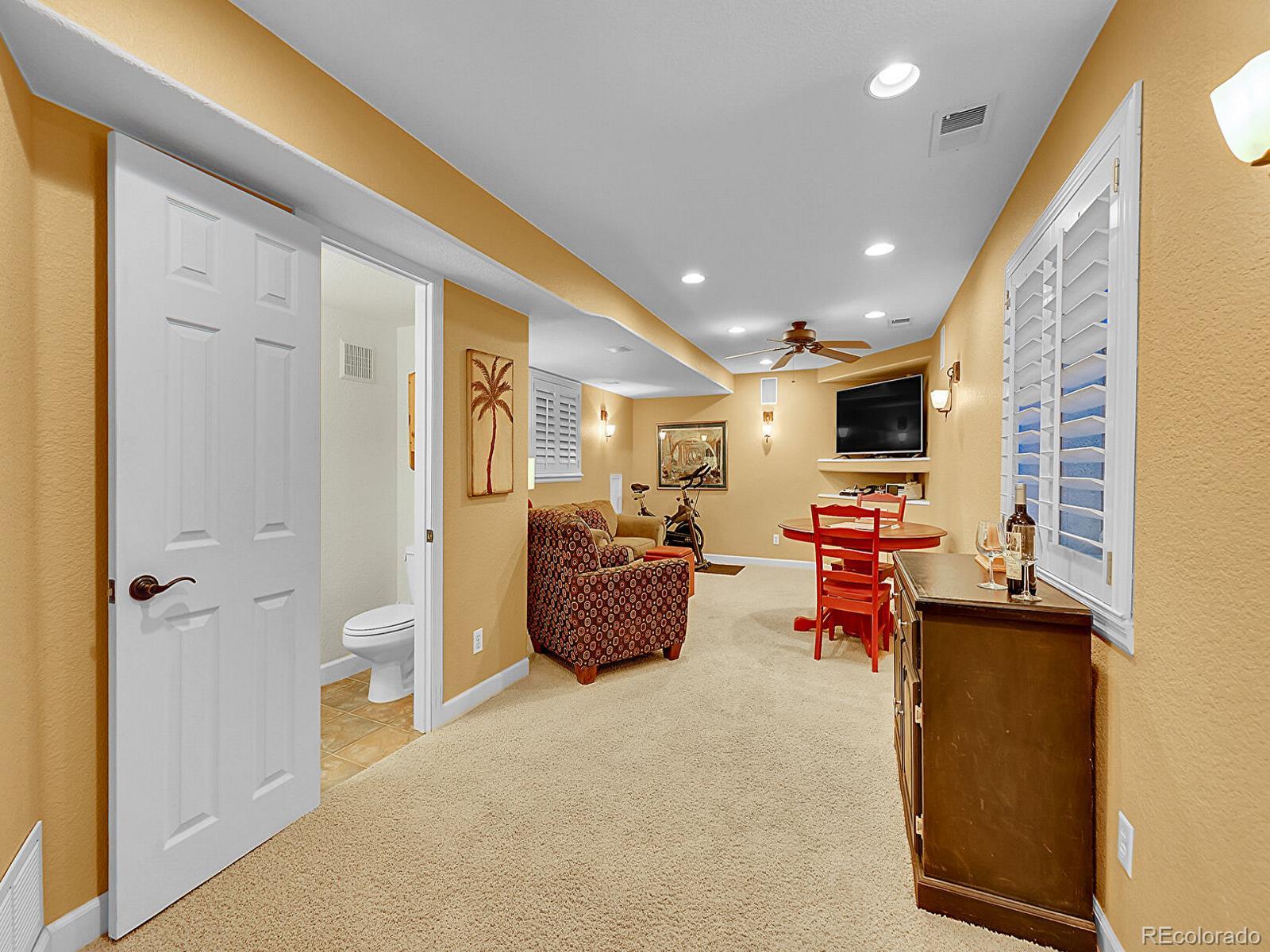 1221 Braewood Avenue Highlands Ranch, CO 80129 - Photo 24 of 45 a living room with furniture and a flat screen tv