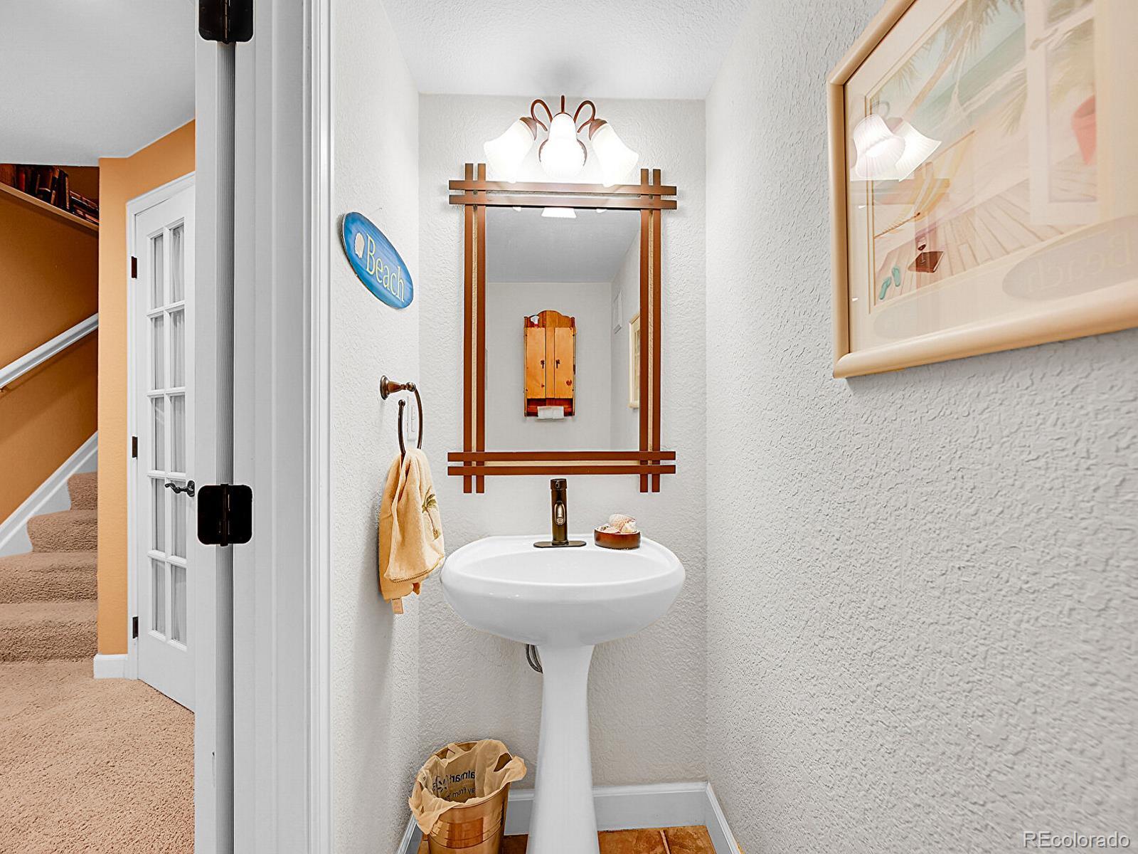 1221 Braewood Avenue Highlands Ranch, CO 80129 - Photo 27 of 45 a bathroom with a sink and a mirror