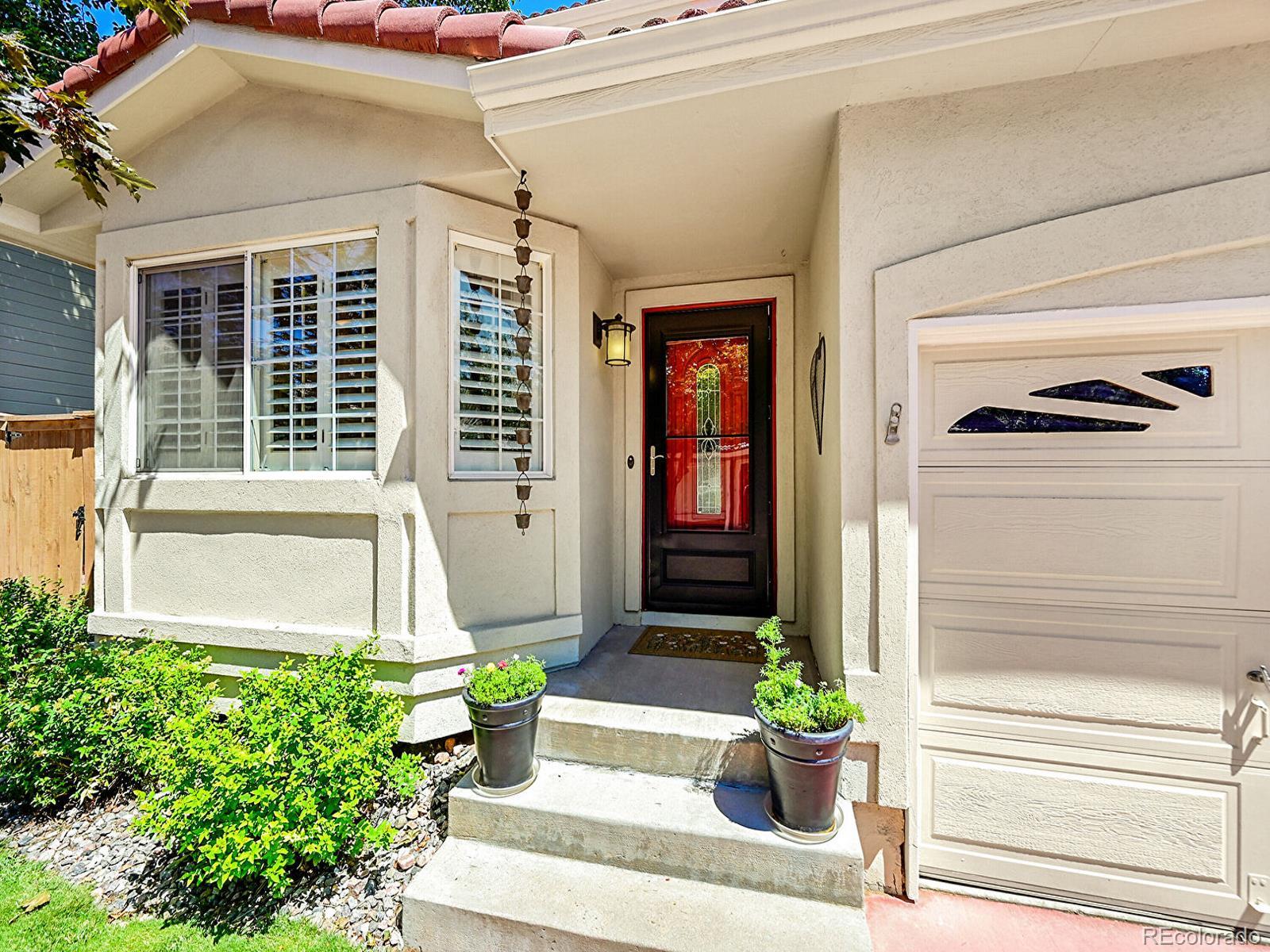 1221 Braewood Avenue Highlands Ranch, CO 80129 - Photo 3 of 45 a front view of a house with a potted plant and a window