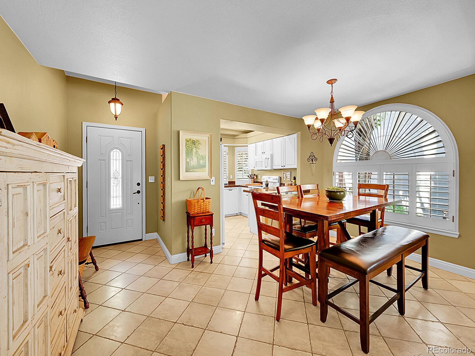 1221 Braewood Avenue Highlands Ranch, CO 80129 - Photo 5 of 45 a view of a dining room with furniture and a chandelier