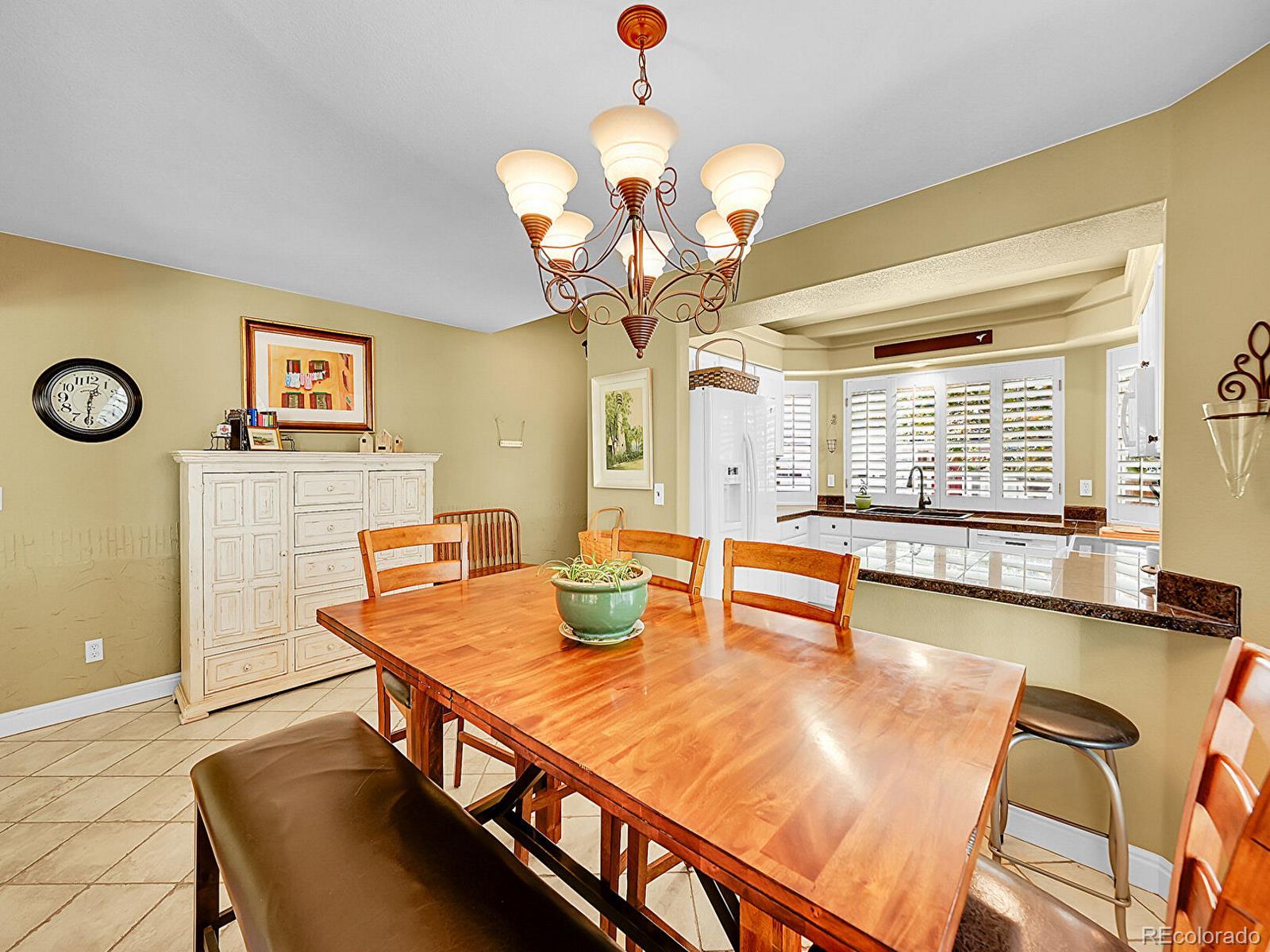 1221 Braewood Avenue Highlands Ranch, CO 80129 - Photo 6 of 45 a view of a dining room with furniture and a chandelier