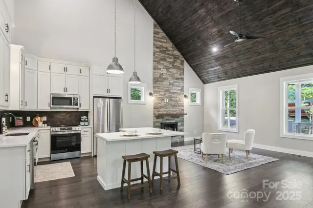 a kitchen with a table chairs stove and refrigerator