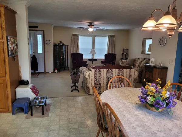a living room with furniture and flowers