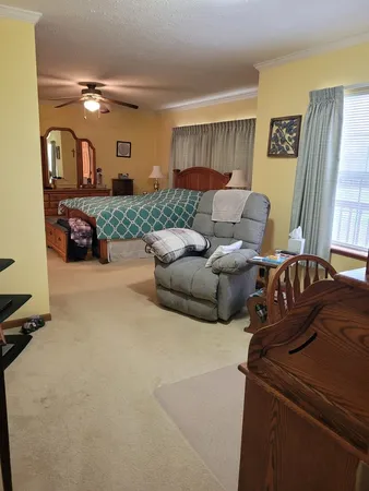 a living room with furniture and a large mirror
