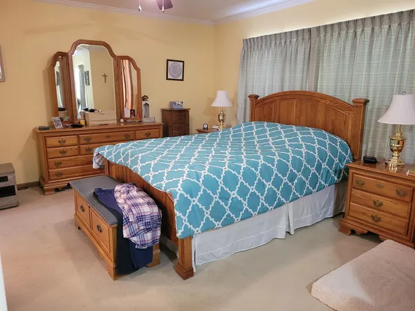 a bedroom with bed and a dresser