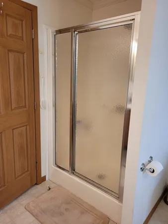 a bathroom with a glass shower door