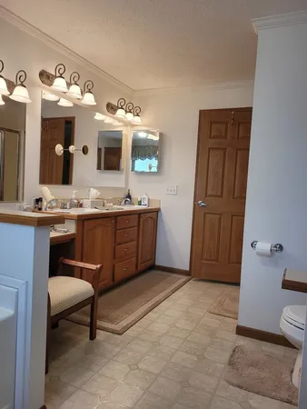 a spacious bathroom with a sink and a mirror