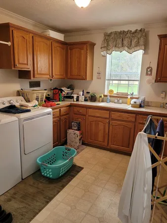 a kitchen with sink cabinets and window
