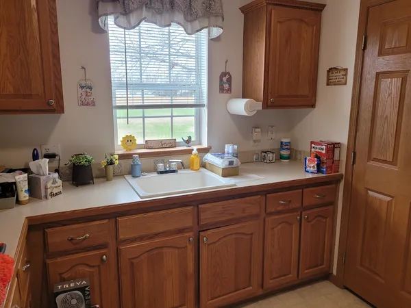 a kitchen with stainless steel appliances granite countertop a sink a cabinets and a window