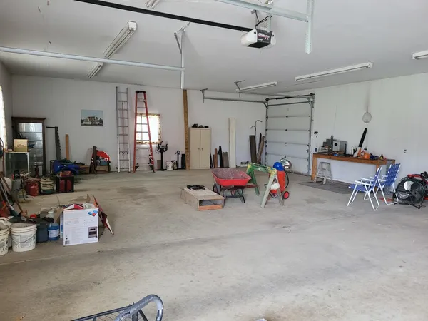 a living room with furniture and a gym machine