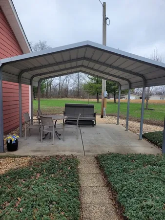 a view of yard with patio