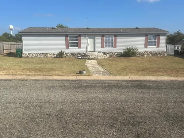 a view of house with a yard