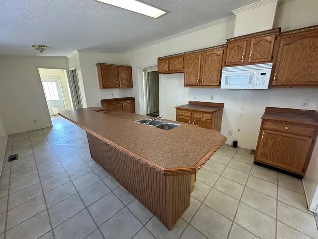a kitchen with stainless steel appliances granite countertop a sink and a stove