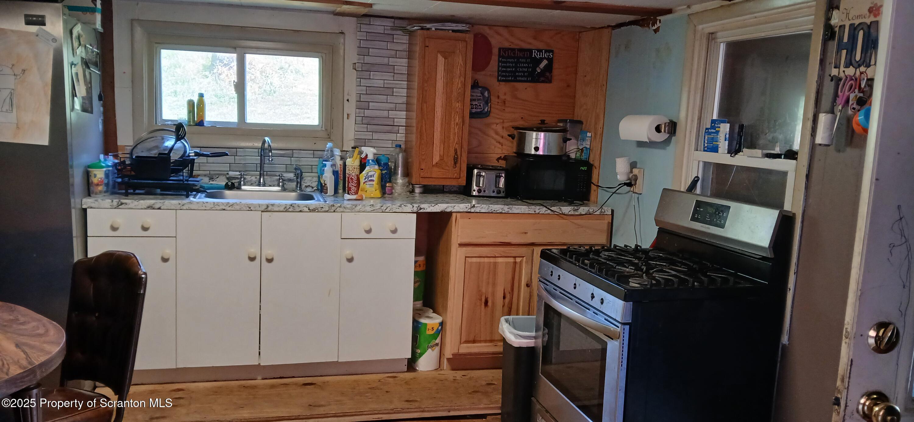4530 Oak Hill Road Susquehanna, PA 18847 - Photo 11 of 40 a kitchen with stainless steel appliances granite countertop a stove a sink and a refrigerator