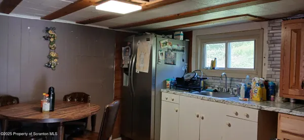 a kitchen with a refrigerator and a stove