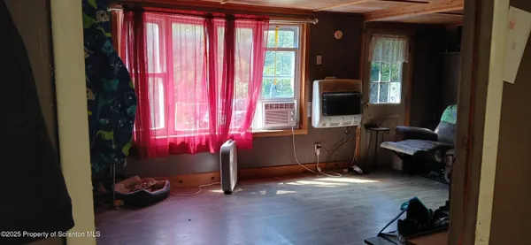 a living room with a fireplace and a floor to ceiling window