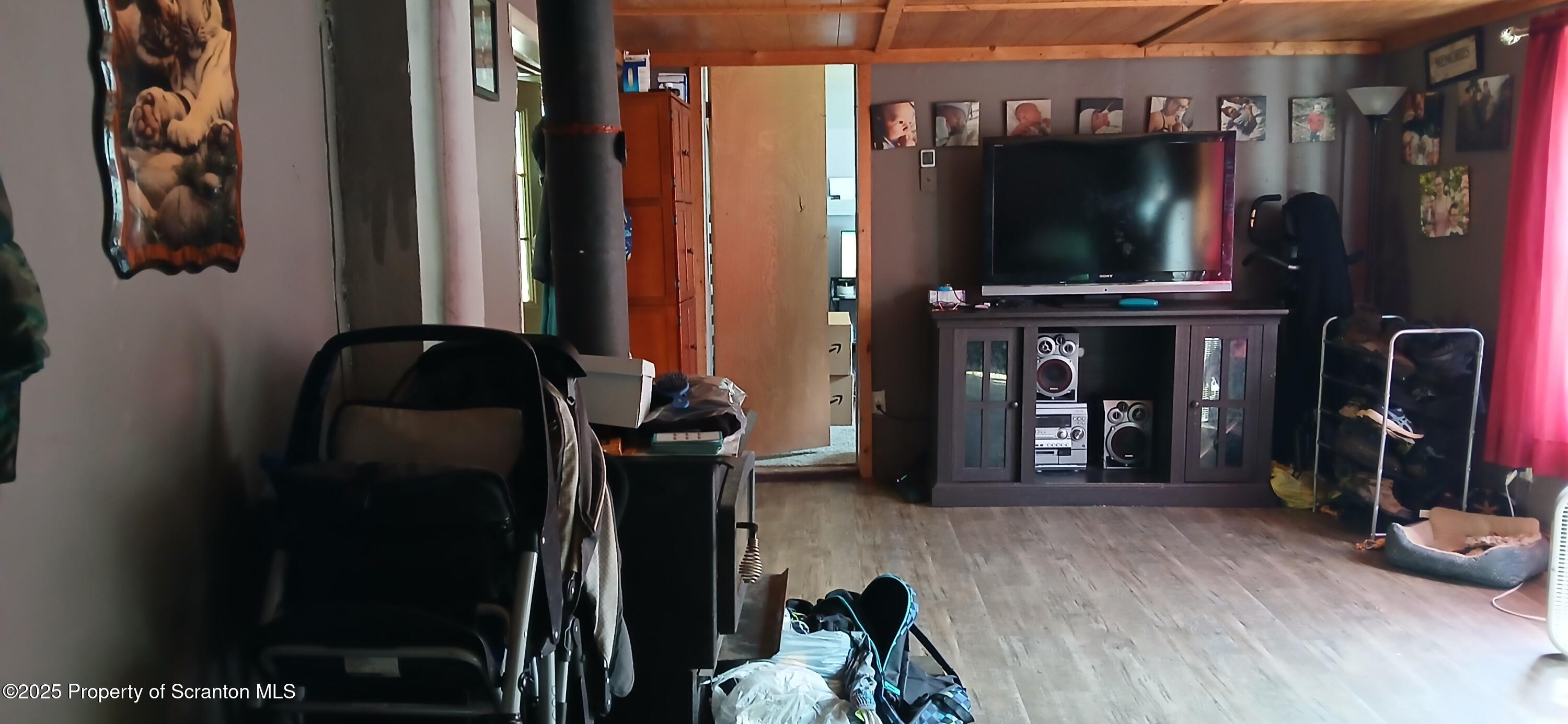 4530 Oak Hill Road Susquehanna, PA 18847 - Photo 16 of 40 a living room with furniture and a flat screen tv