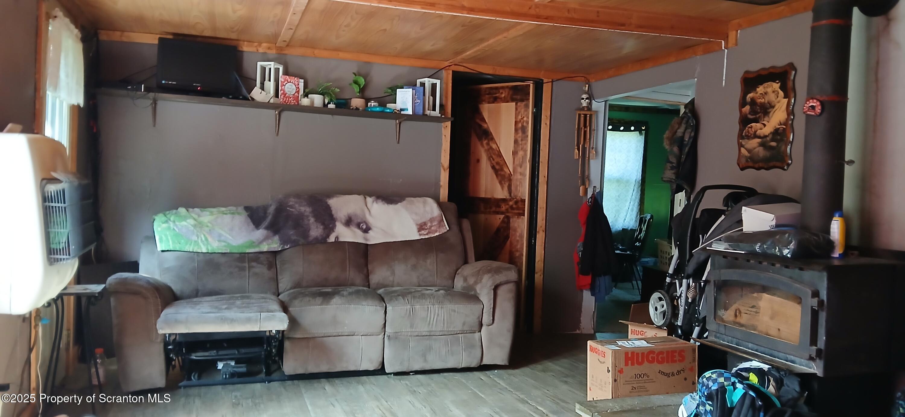 4530 Oak Hill Road Susquehanna, PA 18847 - Photo 20 of 40 a living room with furniture and a fireplace