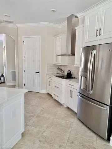 a kitchen with stainless steel appliances a refrigerator sink and cabinets