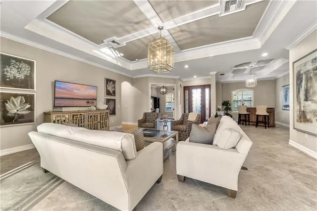 a living room with furniture and a chandelier