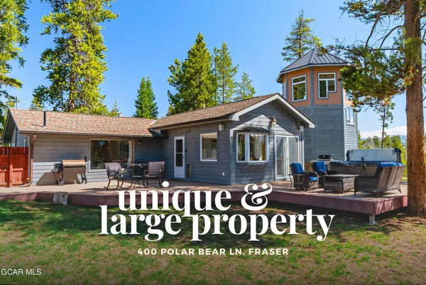 a living room with furniture large window and a fireplace