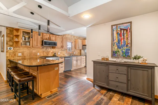 a kitchen with stainless steel appliances a stove a microwave and cabinets