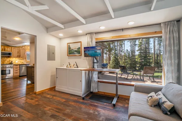 a bathroom with a granite countertop shower a sink and a window