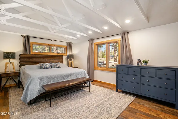 a bedroom with a bed and a large window