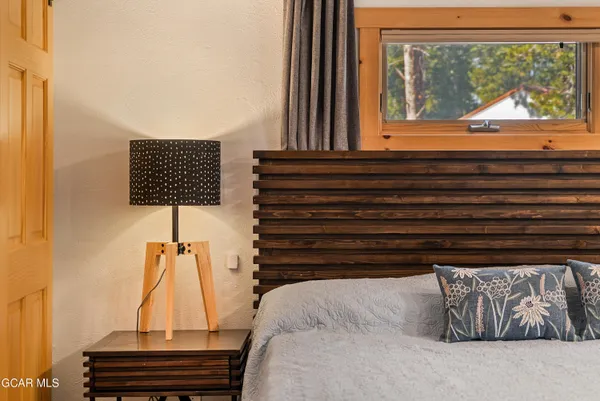 a bedroom with two beds and a window