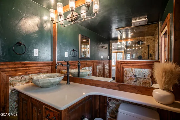 a bathroom with a sink and mirror