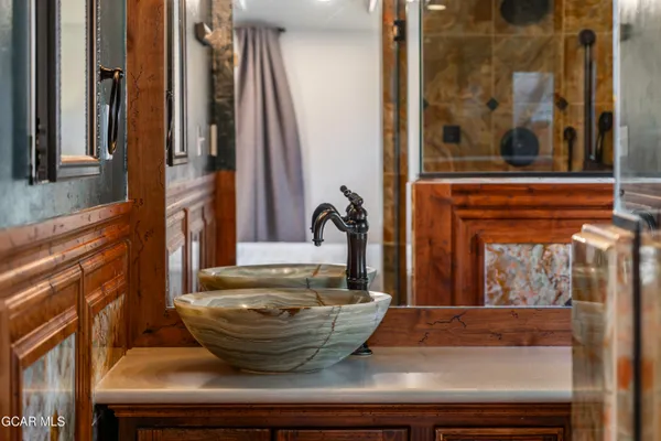 a bathroom with a sink a toilet a mirror and shower