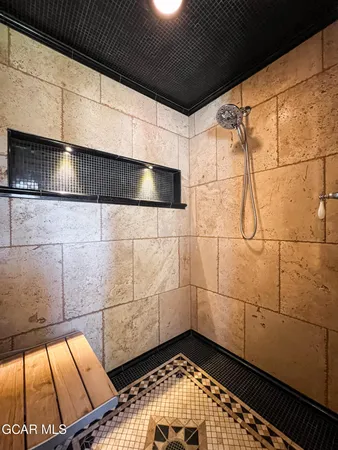 a bathroom with a shower and a mirror