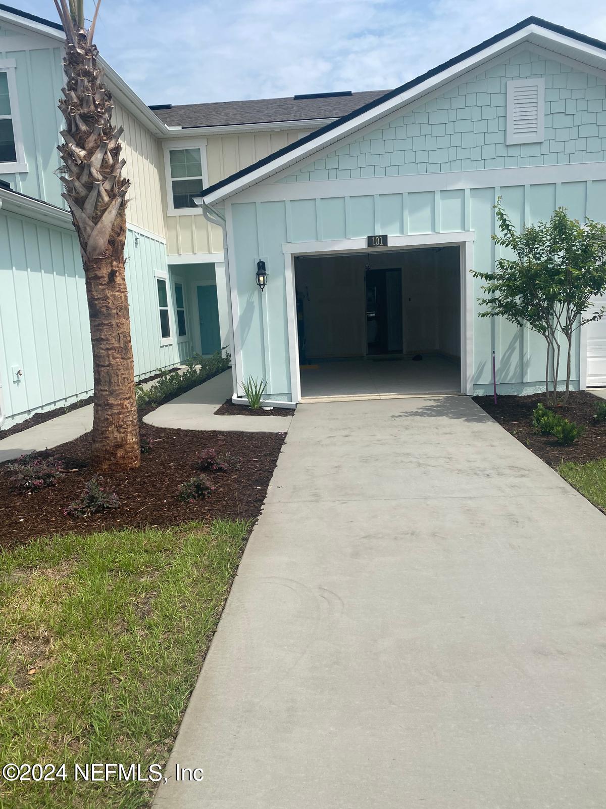 101 Tidal Bch Avenue St. Augustine, FL 32095 - Photo 13 of 13 a front view of a house with a yard and garage