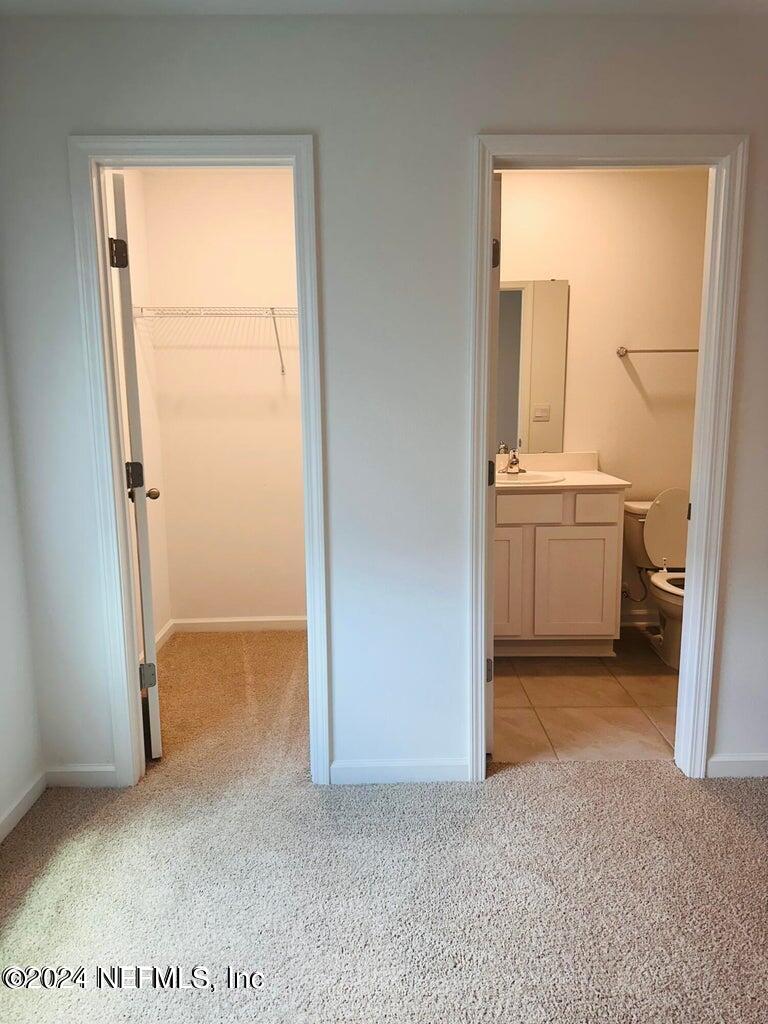 101 Tidal Bch Avenue St. Augustine, FL 32095 - Photo 8 of 13 an empty room with cabinet and mirror