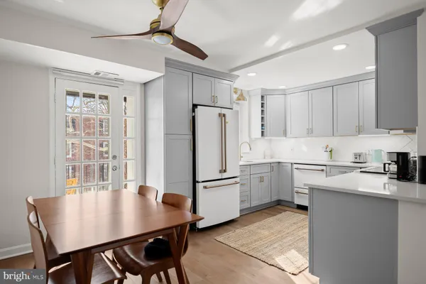 a kitchen with refrigerator cabinets and wooden floor