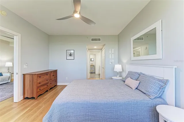 a spacious bedroom with a bed and a dresser