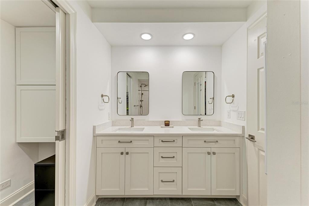 3191 Matecumbe Key Road, Unit 307 Punta Gorda, FL 33955 - Photo 19 of 40 a spacious bathroom with a double vanity sink a mirror and a