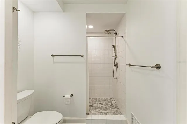 a bathroom with a shower toilet and sink