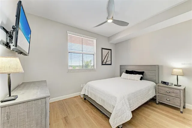 a bedroom with a bed and a night stand on the dresser