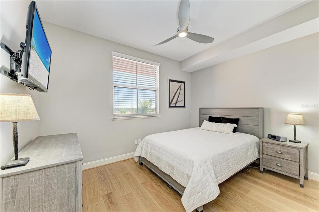 3191 Matecumbe Key Road, Unit 307 Punta Gorda, FL 33955 - Photo 21 of 40 a bedroom with a bed and a night stand on the dresser